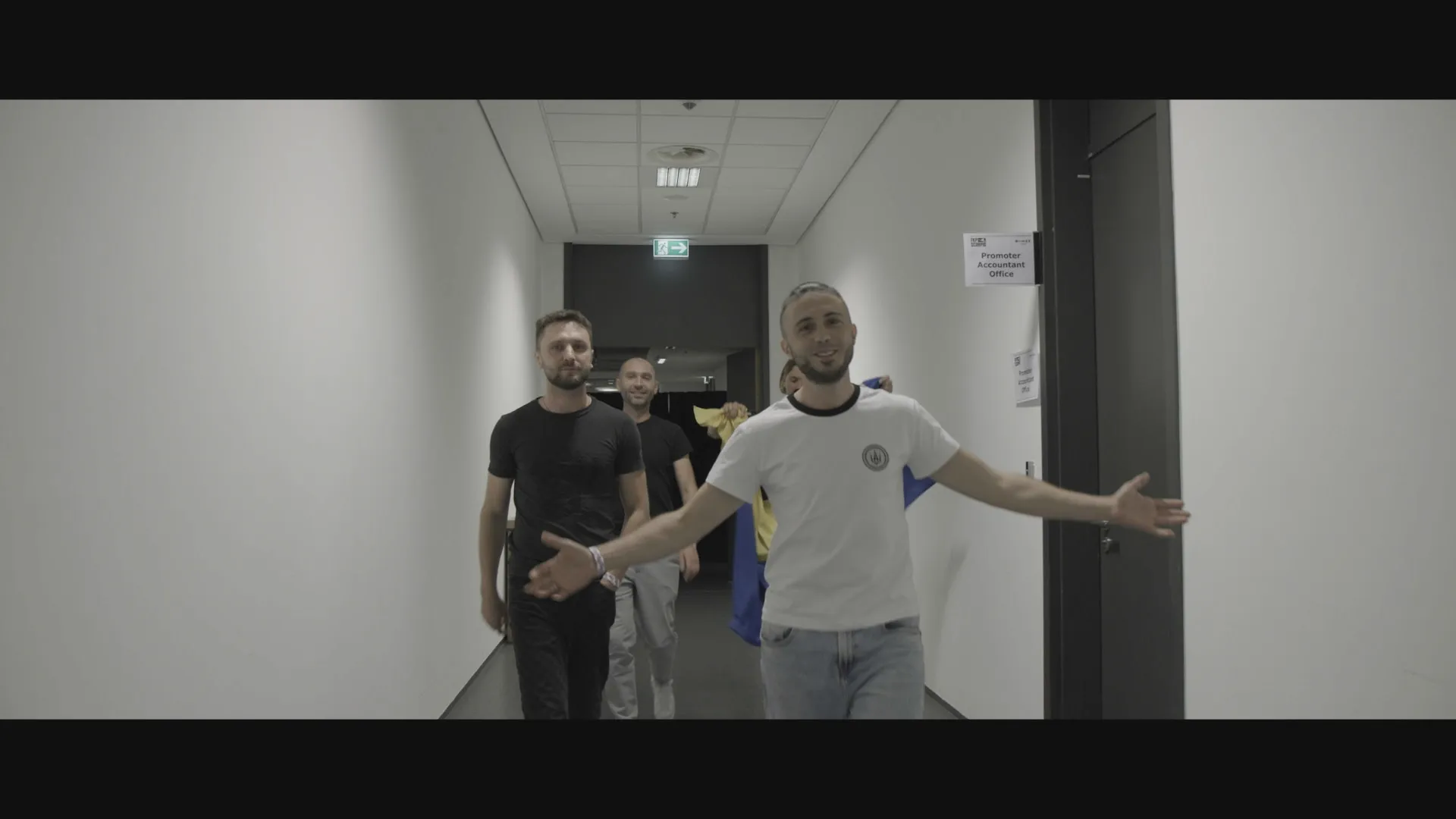 Band members walk backstage before a performance