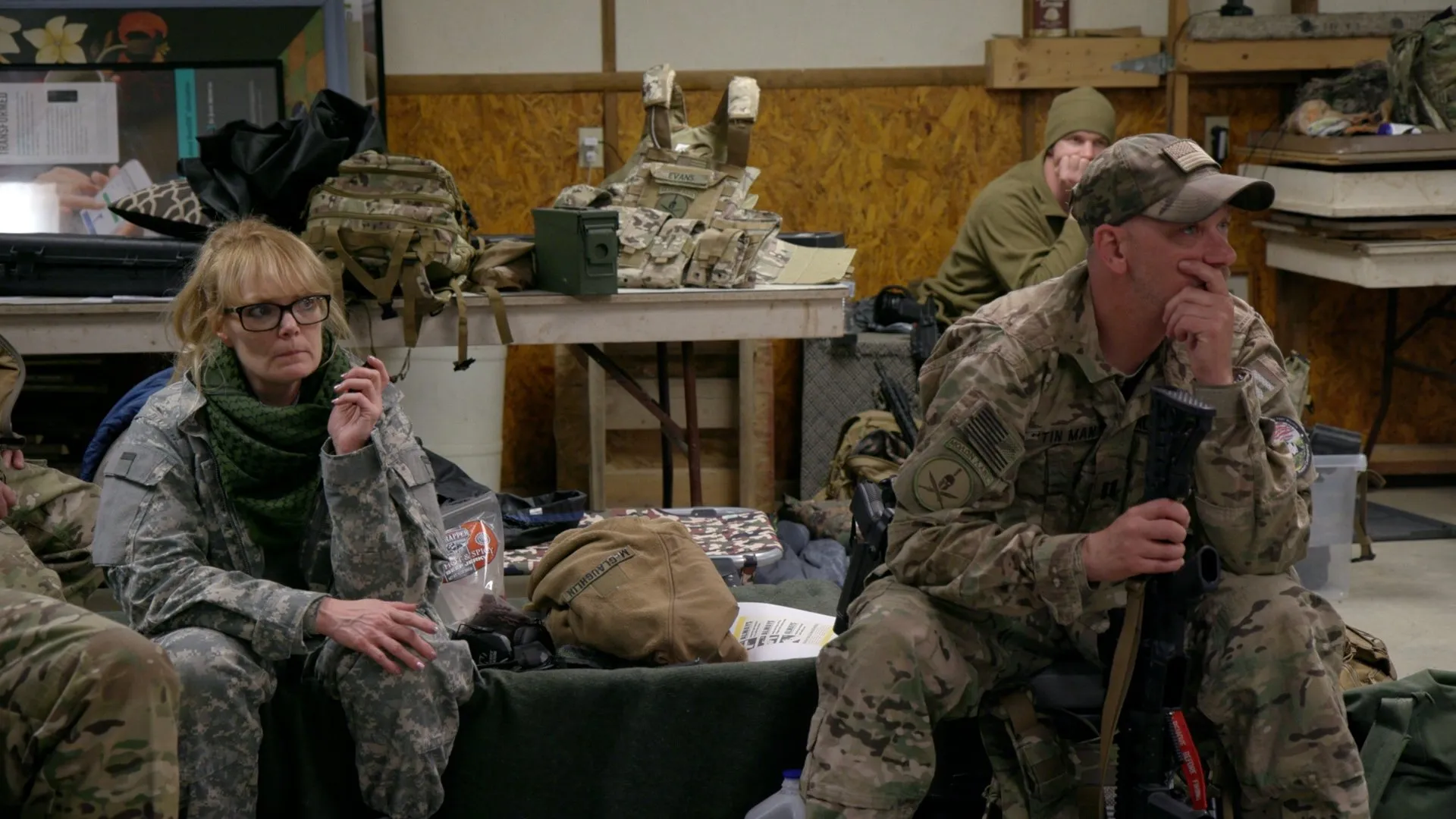Militia members sit together at their base during a briefing